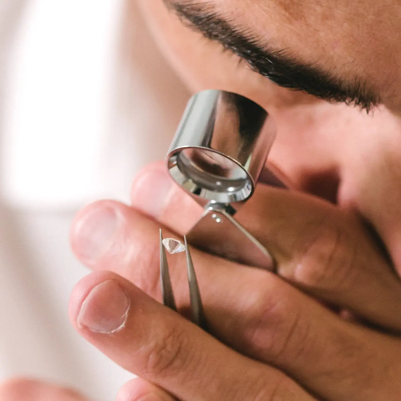 Gemmologist examining the clarity of a round diamond