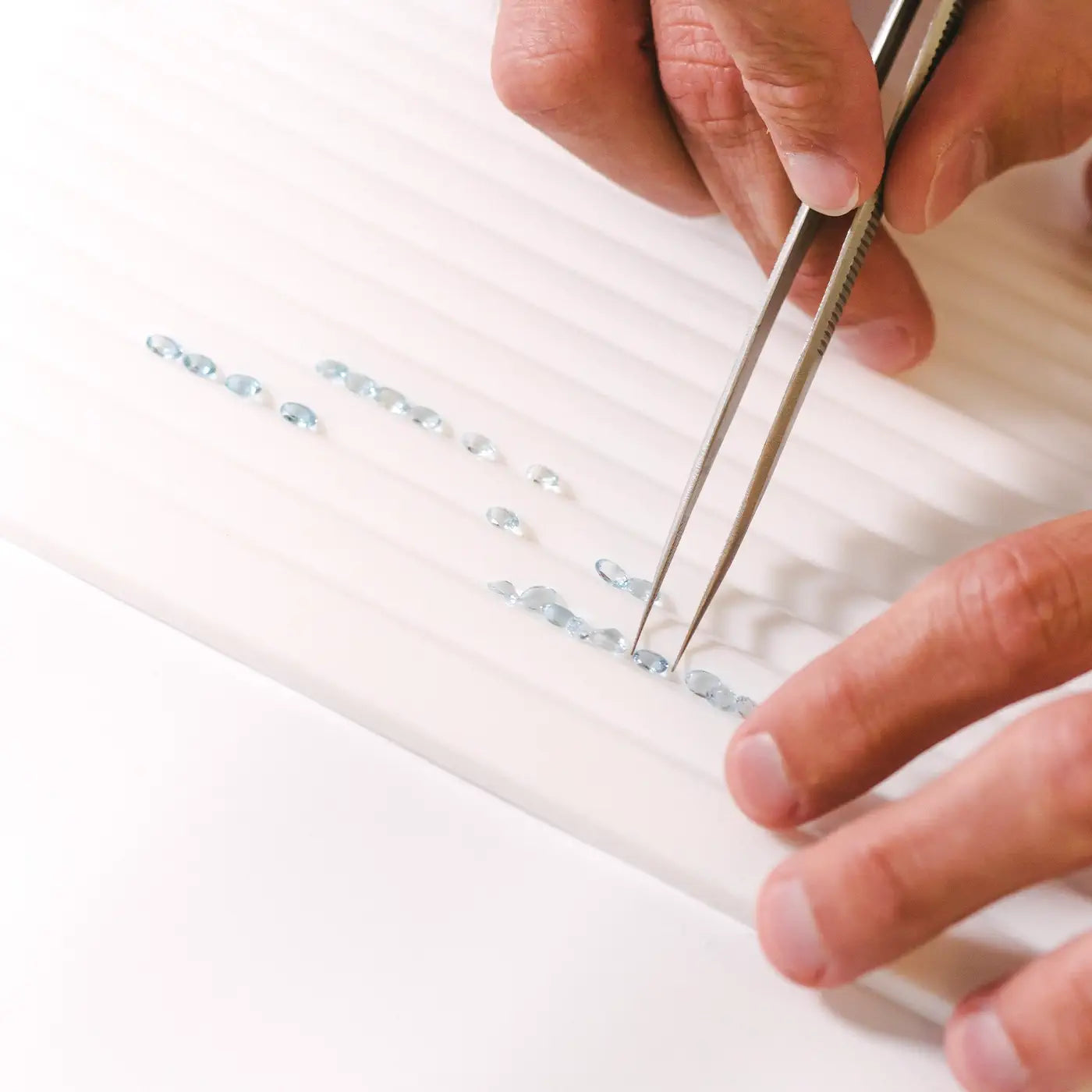 Selecting a line of oval aquamarines for a bracelet