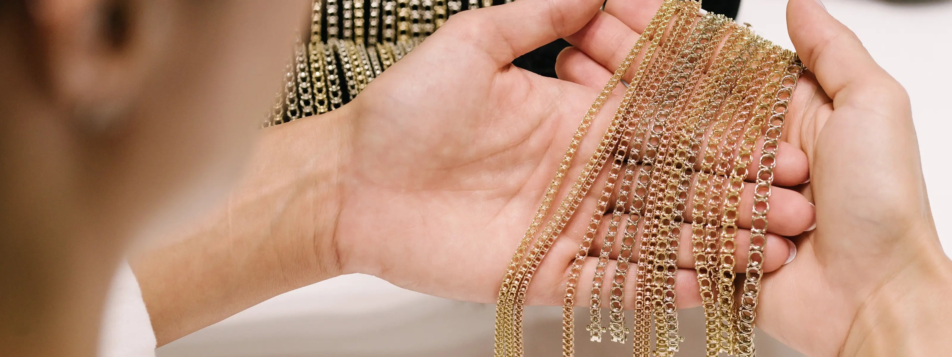 Tennis bracelets in 18k white, yellow and rose gold being examined after assembly of the mounting